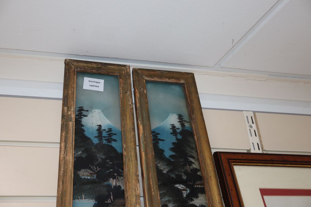 A pair of Japanese reverse painted glass panels, framed